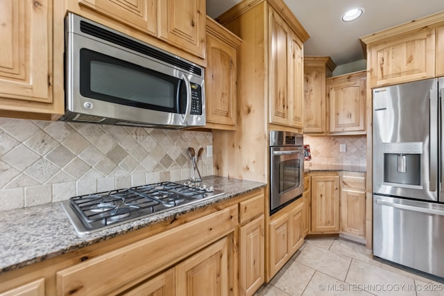 3012 W Mobile St, Broken Arrow, OK 74011 - kitchen with stainless steel appliances, light stone counters, light brown cabinets, light tile patterned floors, and recessed lighting