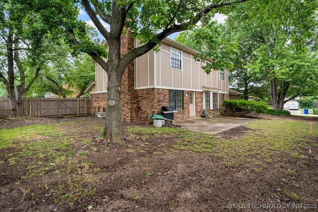 2612 W Quincy St, Broken Arrow, OK 74012 - back of house featuring a patio area, a chimney, and brick siding