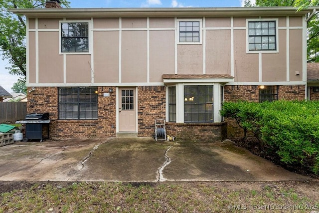 2612 W Quincy St, Broken Arrow, OK 74012 - rear view of house featuring a patio area, a chimney, and brick siding