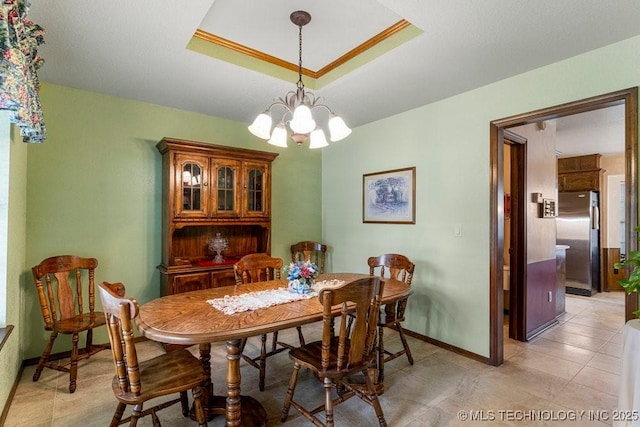 2612 W Quincy St, Broken Arrow, OK 74012 - dining area featuring a chandelier, a tray ceiling, baseboards, and light tile patterned floors