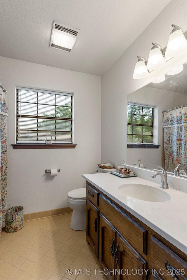 2612 W Quincy St, Broken Arrow, OK 74012 - full bathroom featuring vanity, healthy amount of natural light, tile patterned floors, and toilet