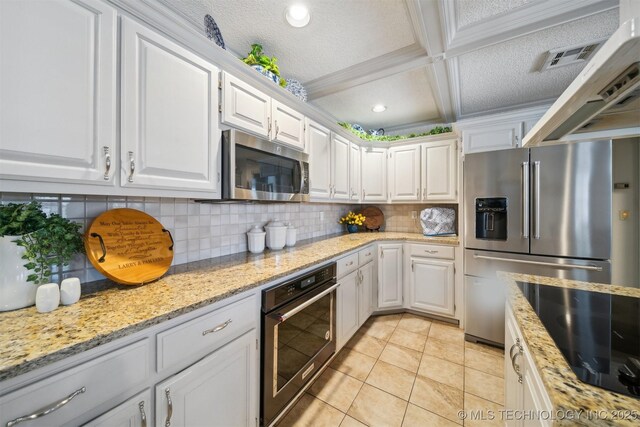 625 Grove Crest Rd, Pryor, OK 74361 - kitchen with stainless steel appliances, white cabinetry, backsplash, a textured ceiling, and light tile patterned flooring