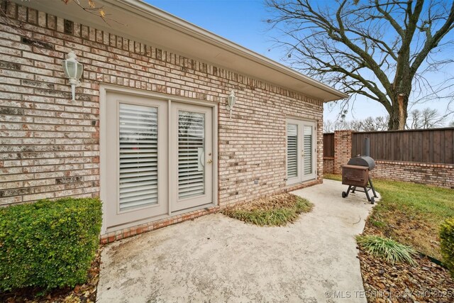 625 Grove Crest Rd, Pryor, OK 74361 - view of exterior entry featuring a patio area and brick siding