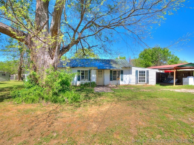 31229 E 682nd Rd, Wagoner, OK 74467 - ranch-style home featuring a front yard, metal roof, and a detached carport