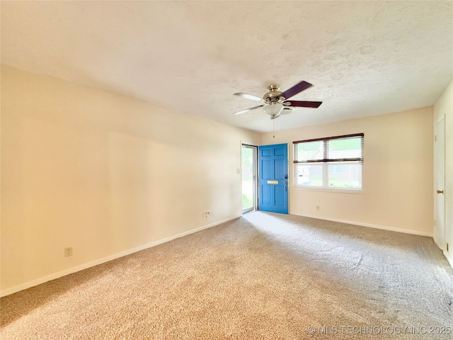 5641 S Newport Ave Unit 5641, Tulsa, OK 74105 - spare room with carpet, a ceiling fan, baseboards, and a textured ceiling