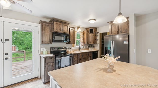 19826 S Covey Ct, Claremore, OK 74019 - kitchen with black appliances, light countertops, and plenty of natural light