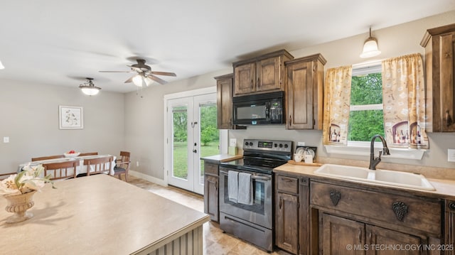 19826 S Covey Ct, Claremore, OK 74019 - kitchen with electric stove, black microwave, a ceiling fan, and light countertops