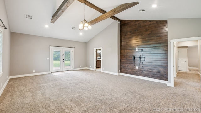 19826 S Covey Ct, Claremore, OK 74019 - unfurnished living room featuring high vaulted ceiling, carpet, a chandelier, french doors, and wooden walls
