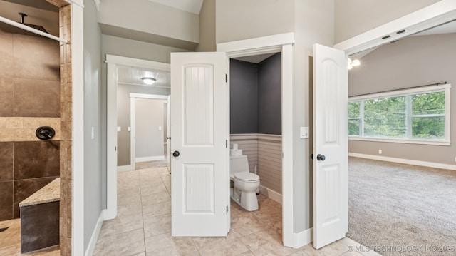 19826 S Covey Ct, Claremore, OK 74019 - bathroom with a tile shower, a wainscoted wall, and tile patterned floors