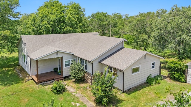 19826 S Covey Ct, Claremore, OK 74019 - view of front of house with a shingled roof, a front lawn, and a deck