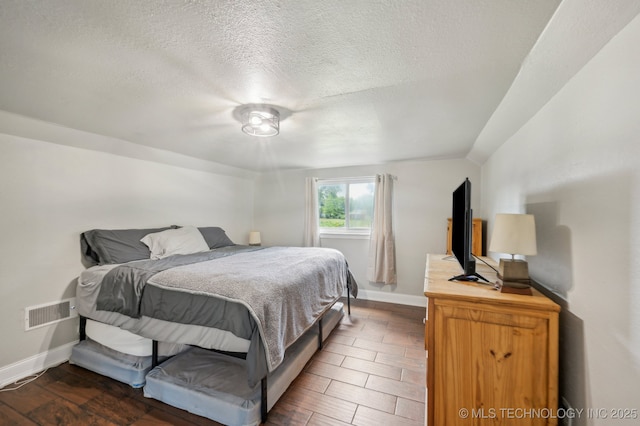 2806 S 136th Ave, Tulsa, OK 74134 - bedroom with baseboards, a textured ceiling, and wood finished floors
