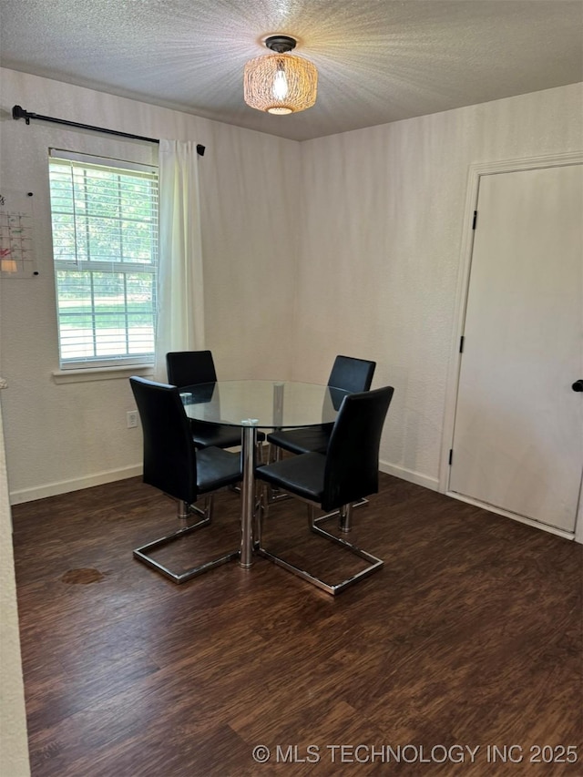 2752 Sawmill, Durant, OK 74701 - dining space featuring wood finished floors, a textured ceiling, and baseboards