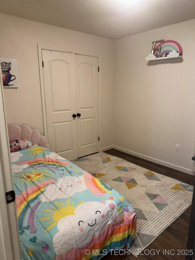 2752 Sawmill, Durant, OK 74701 - bedroom featuring wood finished floors, a closet, and baseboards