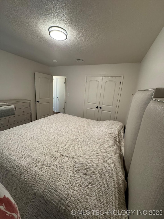 2752 Sawmill, Durant, OK 74701 - bedroom with a textured ceiling and a closet