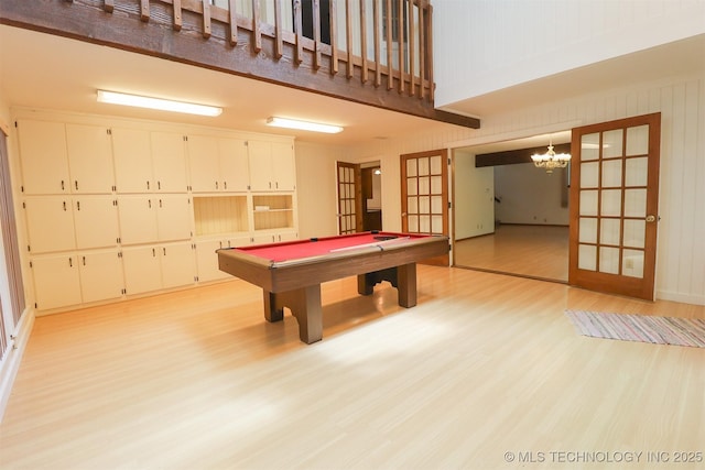 9337 S Lakewood Ave, Tulsa, OK 74137 - recreation room with light wood-style flooring, billiards table, a chandelier, french doors, and a towering ceiling