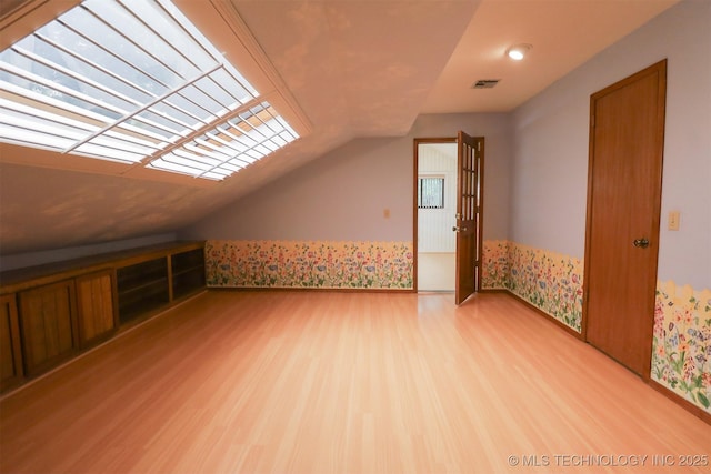 9337 S Lakewood Ave, Tulsa, OK 74137 - additional living space featuring lofted ceiling and wood finished floors