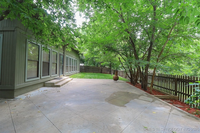 9337 S Lakewood Ave, Tulsa, OK 74137 - fenced backyard with a patio