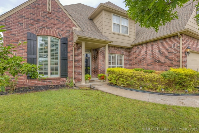 5006 S 164th E Ave, Tulsa, OK 74134 - view of front of house featuring a shingled roof, brick siding, a front yard, and a garage