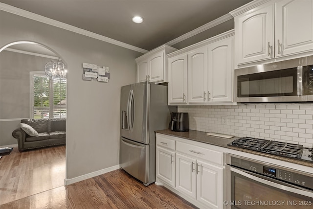 5006 S 164th E Ave, Tulsa, OK 74134 - kitchen with appliances with stainless steel finishes, baseboards, dark countertops, white cabinets, and dark wood finished floors