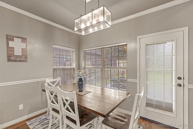5006 S 164th E Ave, Tulsa, OK 74134 - dining room featuring crown molding, baseboards, wood finished floors, and a chandelier