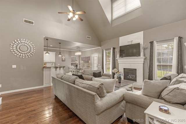 5006 S 164th E Ave, Tulsa, OK 74134 - living room with high vaulted ceiling, dark wood finished floors, a ceiling fan, healthy amount of natural light, and a brick fireplace