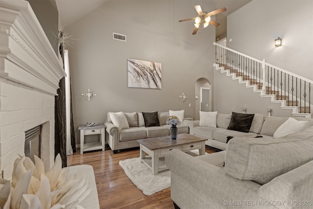 5006 S 164th E Ave, Tulsa, OK 74134 - living area with arched walkways, high vaulted ceiling, wood finished floors, a ceiling fan, and stairs