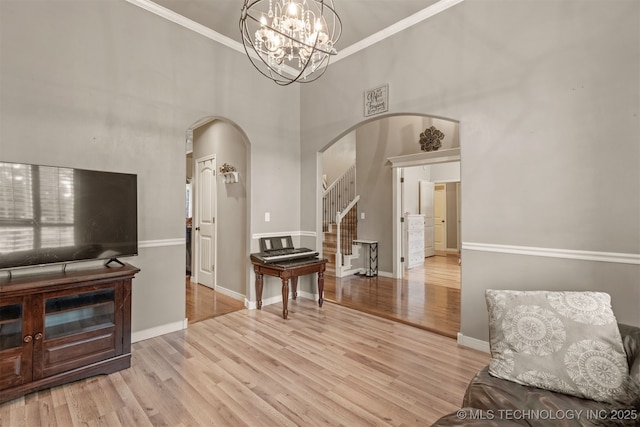 5006 S 164th E Ave, Tulsa, OK 74134 - sitting room with arched walkways, stairs, wood finished floors, crown molding, and baseboards