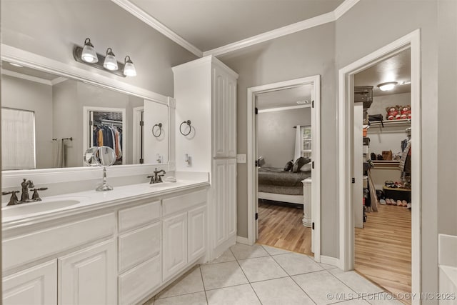 5006 S 164th E Ave, Tulsa, OK 74134 - ensuite bathroom with crown molding, double vanity, a walk in closet, and tile patterned flooring