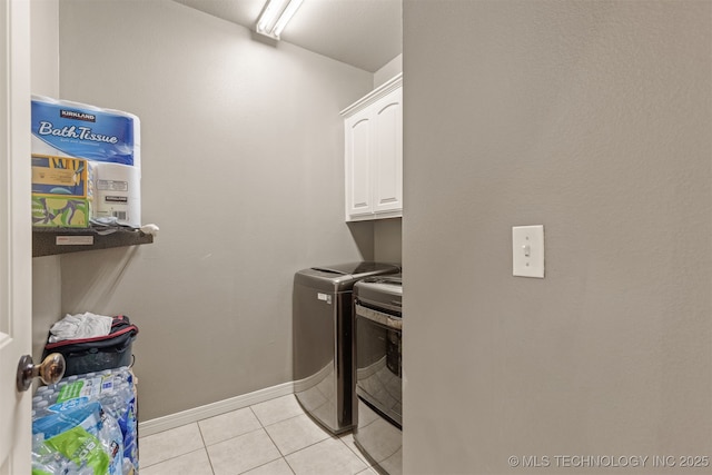 5006 S 164th E Ave, Tulsa, OK 74134 - washroom with washer and clothes dryer, cabinet space, light tile patterned floors, and baseboards