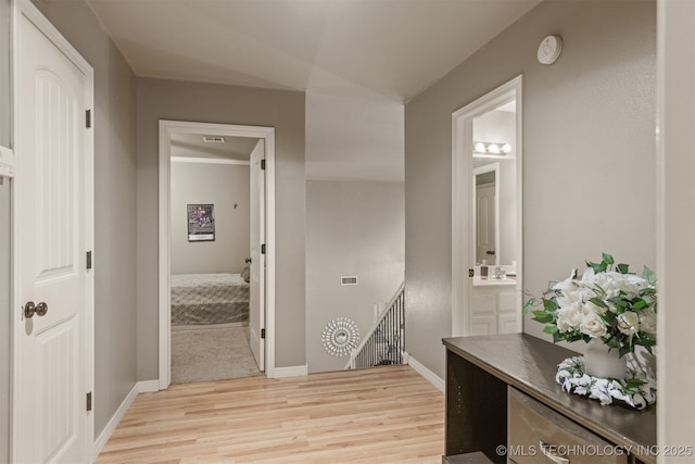 5006 S 164th E Ave, Tulsa, OK 74134 - hall with an upstairs landing, light wood-style flooring, a sink, and baseboards