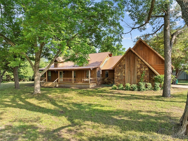 3419 State Highway 199, Dickson, OK 73401 - view of front facade with stone siding, board and batten siding, covered porch, and a front lawn