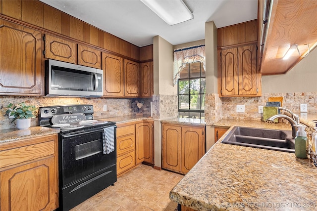 3419 State Highway 199, Dickson, OK 73401 - kitchen with black / electric stove, stainless steel microwave, light countertops, and decorative backsplash