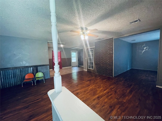 910 Race St, Boswell, OK 74727 - spare room featuring ceiling fan, wood finished floors, and a textured ceiling