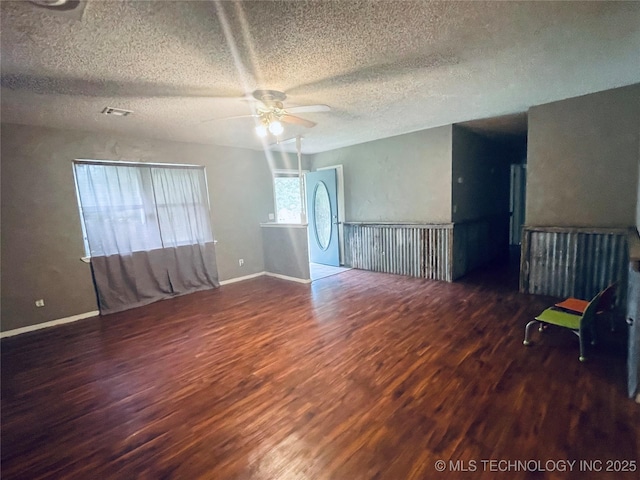 910 Race St, Boswell, OK 74727 - unfurnished room with wood finished floors, ceiling fan, a textured ceiling, and baseboards