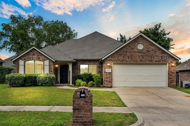 4204 W Freeport St, Broken Arrow, OK 74012 - view of front of house with brick siding, roof with shingles, concrete driveway, and a yard