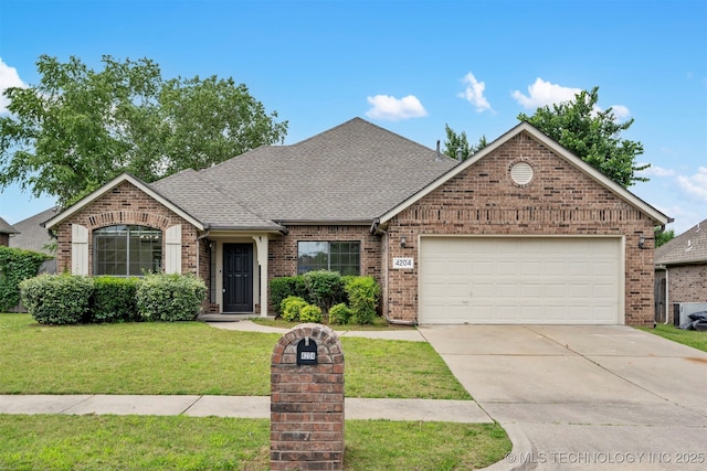 4204 W Freeport St, Broken Arrow, OK 74012 - view of front of house with brick siding, driveway, a front yard, and an attached garage
