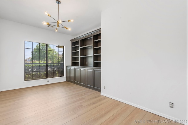 4204 W Freeport St, Broken Arrow, OK 74012 - unfurnished room with a chandelier, light wood-style floors, and baseboards
