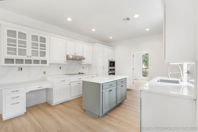 4204 W Freeport St, Broken Arrow, OK 74012 - kitchen featuring under cabinet range hood, a sink, white cabinetry, built in microwave, and stainless steel oven
