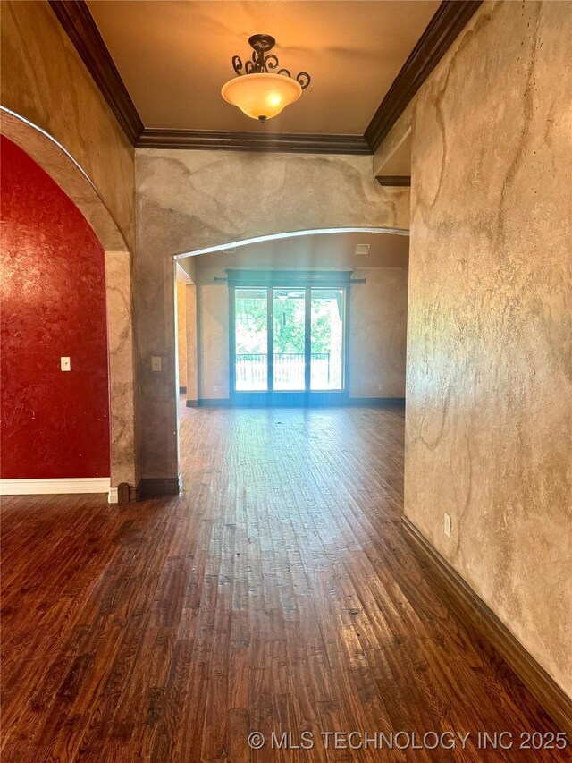 2508 E 140th Pl S, Jenks, OK 74008 - unfurnished room featuring ornamental molding, wood-type flooring, arched walkways, baseboards, and a textured wall