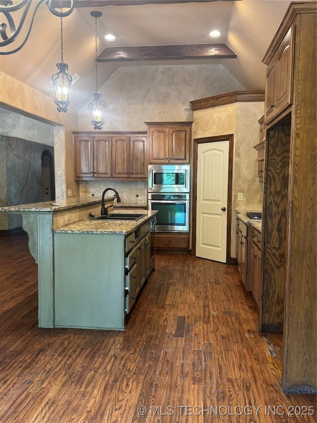 2508 E 140th Pl S, Jenks, OK 74008 - kitchen featuring stainless steel appliances, vaulted ceiling, a sink, dark wood-style flooring, and light stone counters