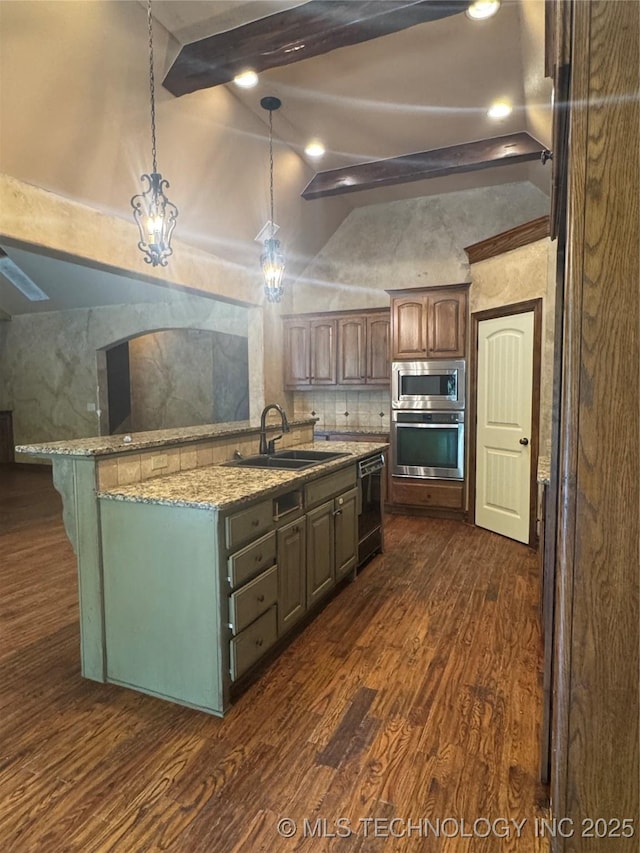 2508 E 140th Pl S, Jenks, OK 74008 - kitchen featuring a sink, appliances with stainless steel finishes, dark wood finished floors, and a center island with sink