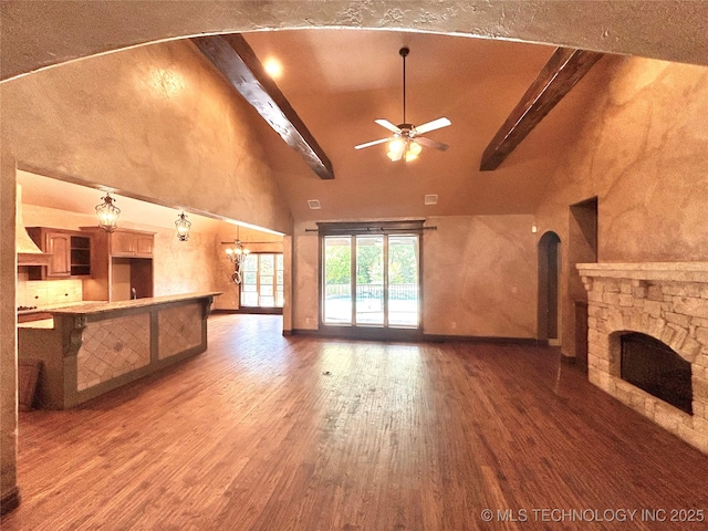 2508 E 140th Pl S, Jenks, OK 74008 - unfurnished living room with high vaulted ceiling, beam ceiling, a ceiling fan, wood finished floors, and a fireplace