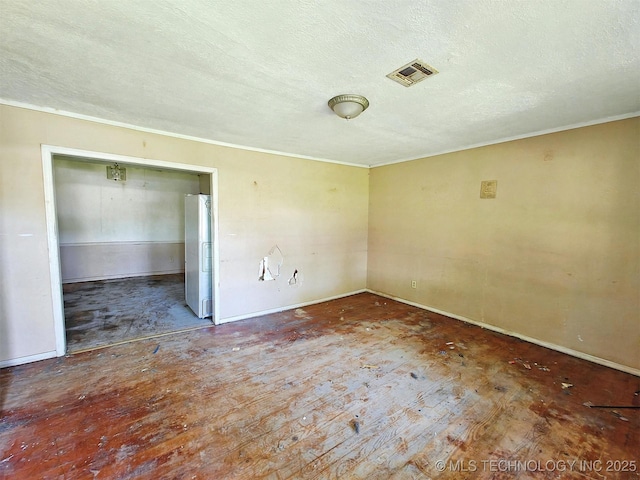 619 E Cherrie St, Tahlequah, OK 74464 - unfurnished room featuring a textured ceiling, baseboards, and ornamental molding