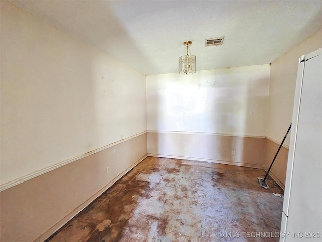 619 E Cherrie St, Tahlequah, OK 74464 - unfurnished room featuring unfinished concrete floors and a chandelier