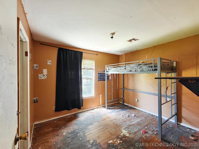 619 E Cherrie St, Tahlequah, OK 74464 - unfurnished bedroom with wood-type flooring