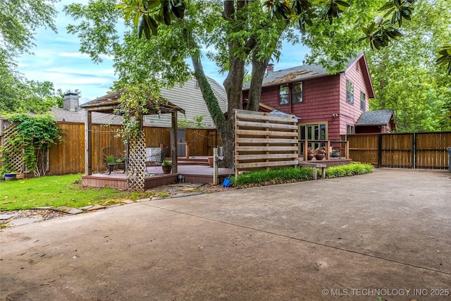 3160 S Owasso Ave, Tulsa, OK 74105 - back of house featuring a deck, a fenced backyard, a chimney, a gazebo, and a patio