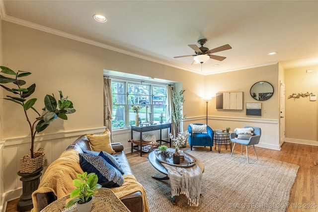 3160 S Owasso Ave, Tulsa, OK 74105 - living area featuring a ceiling fan, wood finished floors, crown molding, a wainscoted wall, and recessed lighting