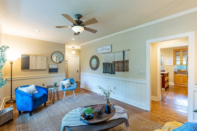 3160 S Owasso Ave, Tulsa, OK 74105 - living area featuring wood finished floors, ceiling fan, wainscoting, and ornamental molding