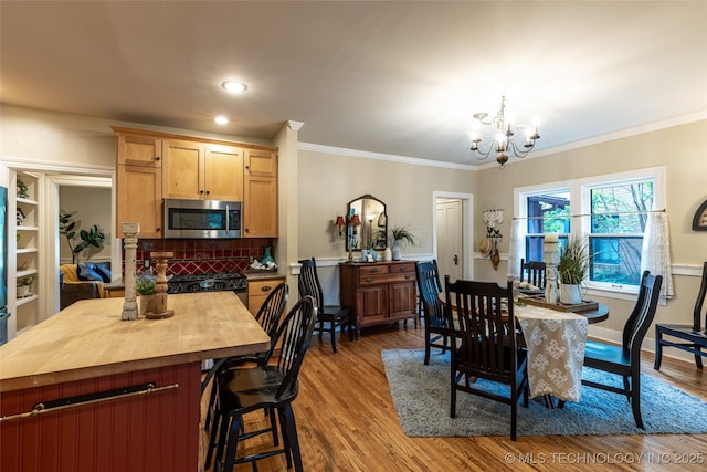 3160 S Owasso Ave, Tulsa, OK 74105 - dining space featuring a chandelier, wood finished floors, crown molding, and recessed lighting
