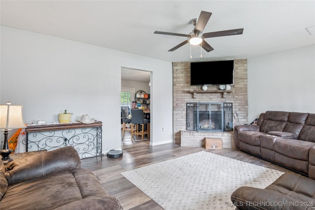 4316 S Ash Ave, Broken Arrow, OK 74011 - living room featuring wood finished floors, a ceiling fan, and a fireplace